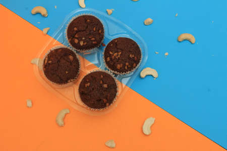 Chocolate muffin isolated on color background. Delicious chocolate muffin with nuts.の写真素材