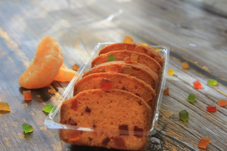 Homemade tutti frutti candied fruit sponge cake on table and colorful background for Christmasの写真素材