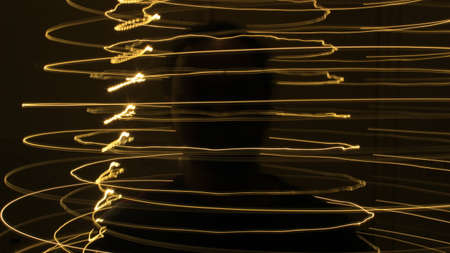 Abstract colorful irregular lines on black background photo with long exposure.Light painting photography.Lights with irregular patterns for overlayの写真素材