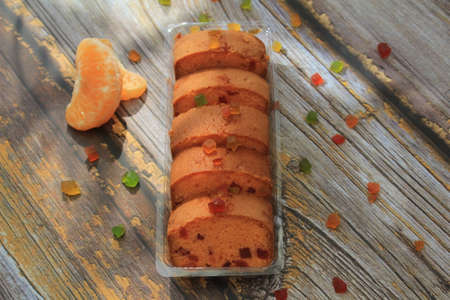Homemade tutti frutti candied fruit sponge cake on table and colorful background for Christmasの写真素材