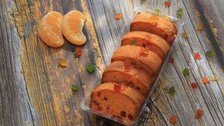 Homemade tutti frutti candied fruit sponge cake on table and colorful background for Christmasの写真素材