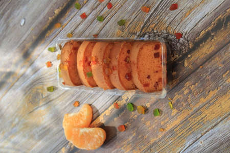 Homemade tutti frutti candied fruit sponge cake on table and colorful background for Christmasの写真素材