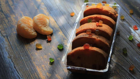 Homemade tutti frutti candied fruit sponge cake on table and colorful background for Christmasの写真素材
