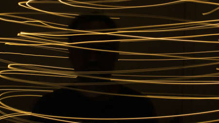 Abstract colorful irregular lines on black background photo with long exposure.Light painting photography.Lights with irregular patterns for overlayの写真素材