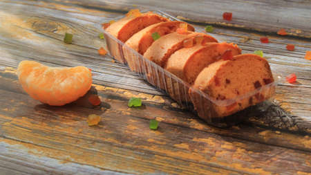 Homemade tutti frutti candied fruit sponge cake on table and colorful background for Christmasの写真素材