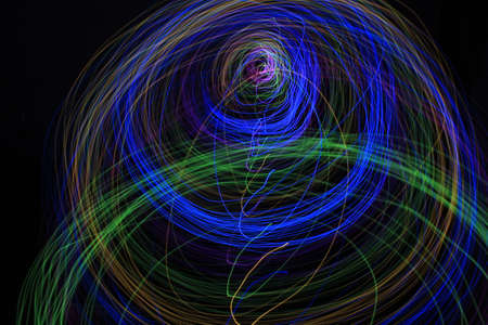 Light painting Abstract colorful irregular lines or patterns on black background with long exposure.の写真素材