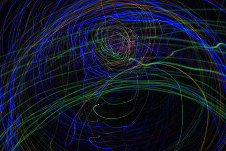 Light painting Abstract colorful irregular lines or patterns on black background with long exposure.の写真素材