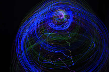 Light painting Abstract colorful irregular lines or patterns on black background with long exposure.の写真素材