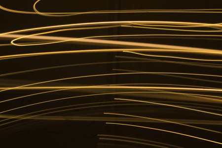 Abstract colorful irregular lines on black background photo with long exposure.Light painting photography.Lights with irregular patterns for overlayの写真素材