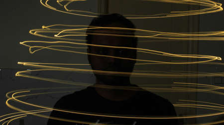 Abstract colorful irregular lines on black background photo with long exposure.Light painting photography.Lights with irregular patterns for overlayの写真素材