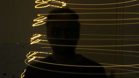 Abstract colorful irregular lines on black background photo with long exposure.Light painting photography.Lights with irregular patterns for overlayの写真素材