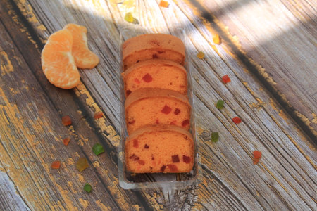 Homemade tutti frutti candied fruit sponge cake on table and colorful background for Christmasの写真素材