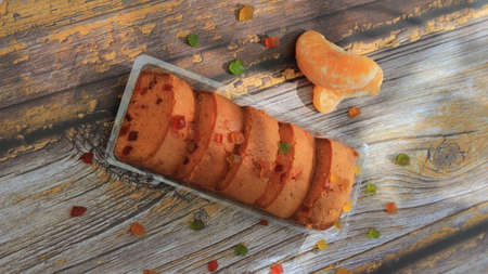 Homemade tutti frutti candied fruit sponge cake on table and colorful background for Christmasの写真素材