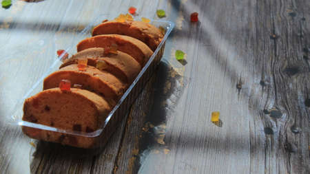 Homemade tutti frutti candied fruit sponge cake on table and colorful background for Christmasの写真素材