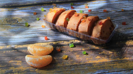 Homemade tutti frutti candied fruit sponge cake on table and colorful background for Christmasの写真素材