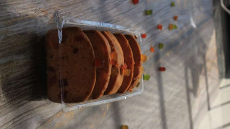 Homemade tutti frutti candied fruit sponge cake on table and colorful background for Christmasの写真素材