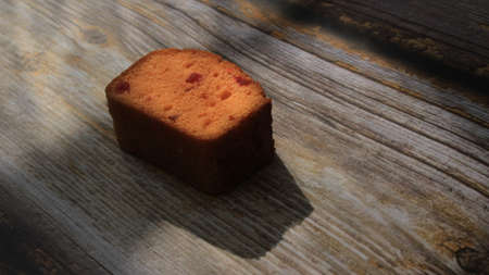 Homemade tutti frutti candied fruit sponge cake on table and colorful background for Christmasの写真素材