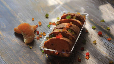 Homemade tutti frutti candied fruit sponge cake on table and colorful background for Christmasの写真素材