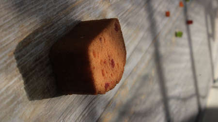 Homemade tutti frutti candied fruit sponge cake on table and colorful background for Christmasの写真素材