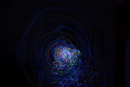 Light painting Abstract colorful irregular lines or patterns on black background with long exposure.の写真素材