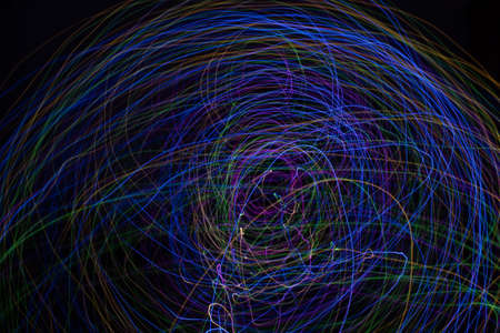 Light painting Abstract colorful irregular lines or patterns on black background with long exposure.の写真素材