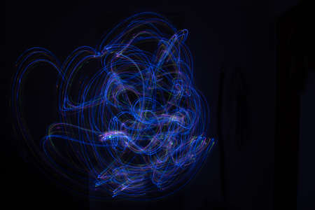 Light painting Abstract colorful irregular lines or patterns on black background with long exposure.の写真素材