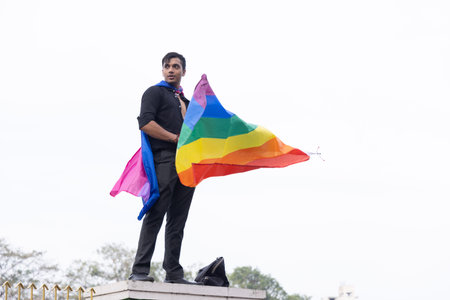 Chennai, Tamilnadu India - June 25 2023 : Rear view of Group of people with pride rainbow flag and...
