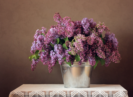 Still-life with a bouquet of lilac in a bucket.の写真素材