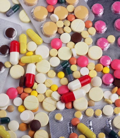 Background of pills and capsules in different colors, top view.の写真素材