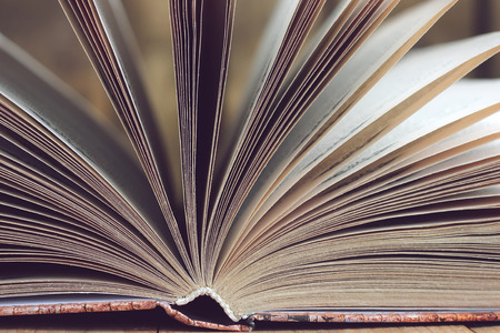 Open book closeup on a wooden table.の写真素材