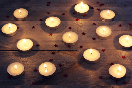 candles and confetti on a wooden platform, top view. romance, celebration, mystery.の写真素材