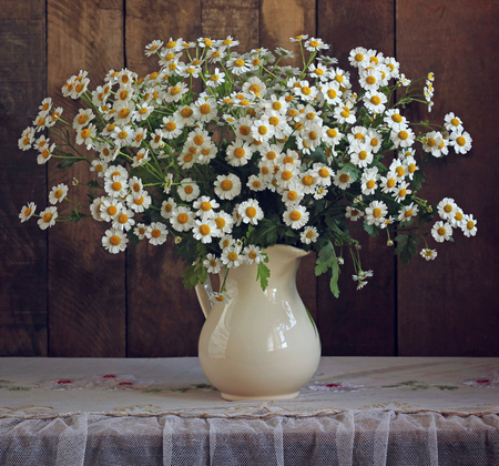 bouquet of garden daisies in a jug. flowers in a vase.の写真素材