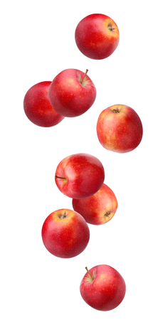 Falling (flying) red apples isolated on white background. whole fruit .の写真素材