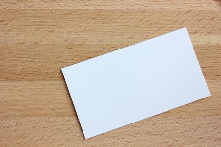 empty business card on a wooden background. the view from the top. white paper card for Your text.の写真素材