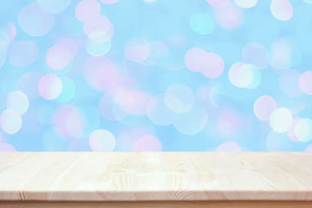 empty wooden table on a blurry blue background with bokeh. Countertop