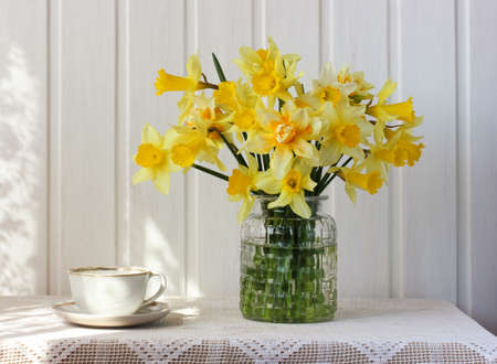 bouquet of yellow daffodils in a glass vaseの写真素材
