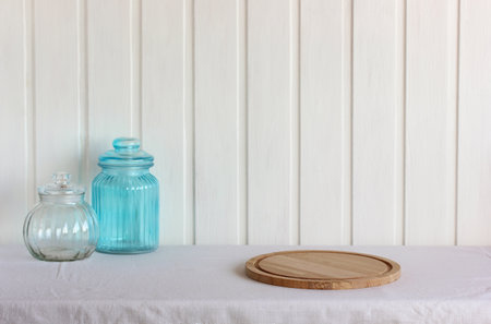 empty table with white tablecloth and cutting board.の写真素材