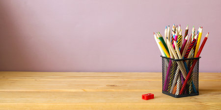 colored pencils in a stand on a wooden table and copy space. education, creativity concept.の写真素材