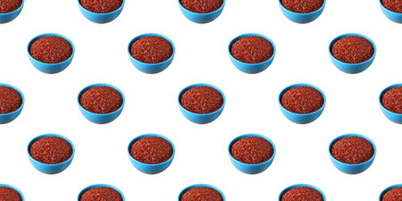 Pattern of blue bowls filled with red cargo rice, creating a visually appealing design on a clean white backdropの写真素材