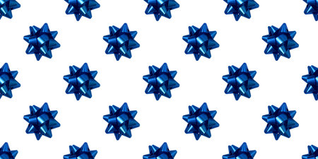 Shiny blue gift bows arranged in a seamless pattern, perfect for holiday or celebration themed designsの写真素材