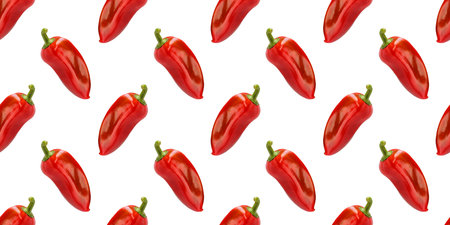 Vibrant, glossy red bell peppers create a striking seamless pattern against a clean white backdropの写真素材