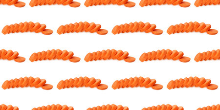 Freshly sliced carrots arranged in a repeating pattern, creating a vibrant and colorful backdrop...