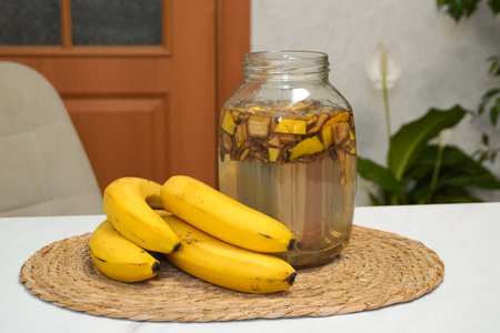 Glass jar with banana peels soaking in water, creating a natural and organic fertilizer for houseplantsの写真素材