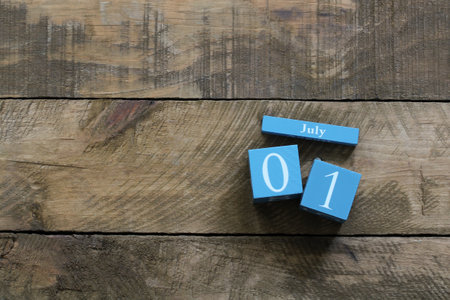 Blue wooden calendar showing july 1st, canada day, on rustic wooden background with copy spaceの写真素材