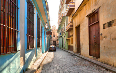 HAVANA, CUBA-MAY 14: Street scene with an old rusty american car on May 14, 2013 in Havana.These classic vintage cars that can be seen all over the country have become a worldwide known symbol of Cuba のeditorial素材