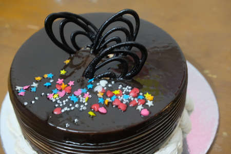 chocolate cake with colorful decoration with chocolate chips and wafersの写真素材