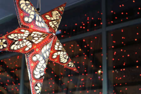 A paper lantern star on a dark background.の写真素材