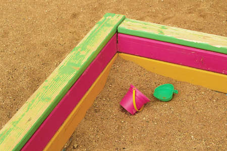 Abandoned children's toys in the sandbox. Pail and molds.の写真素材