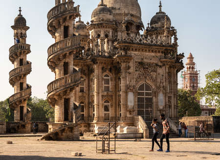 Junagadh, Gujarat, India - December 2018: A young couple walks past the beautifully ornate architecture of the Mahabat Maqbara mausoleum in the city.のeditorial素材