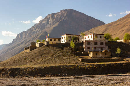 The traditional houses spread around a hill with the backdrop of high barren mountains in the village of Kaza in the Spiti Valley in Himachal Pradesh, India.の写真素材